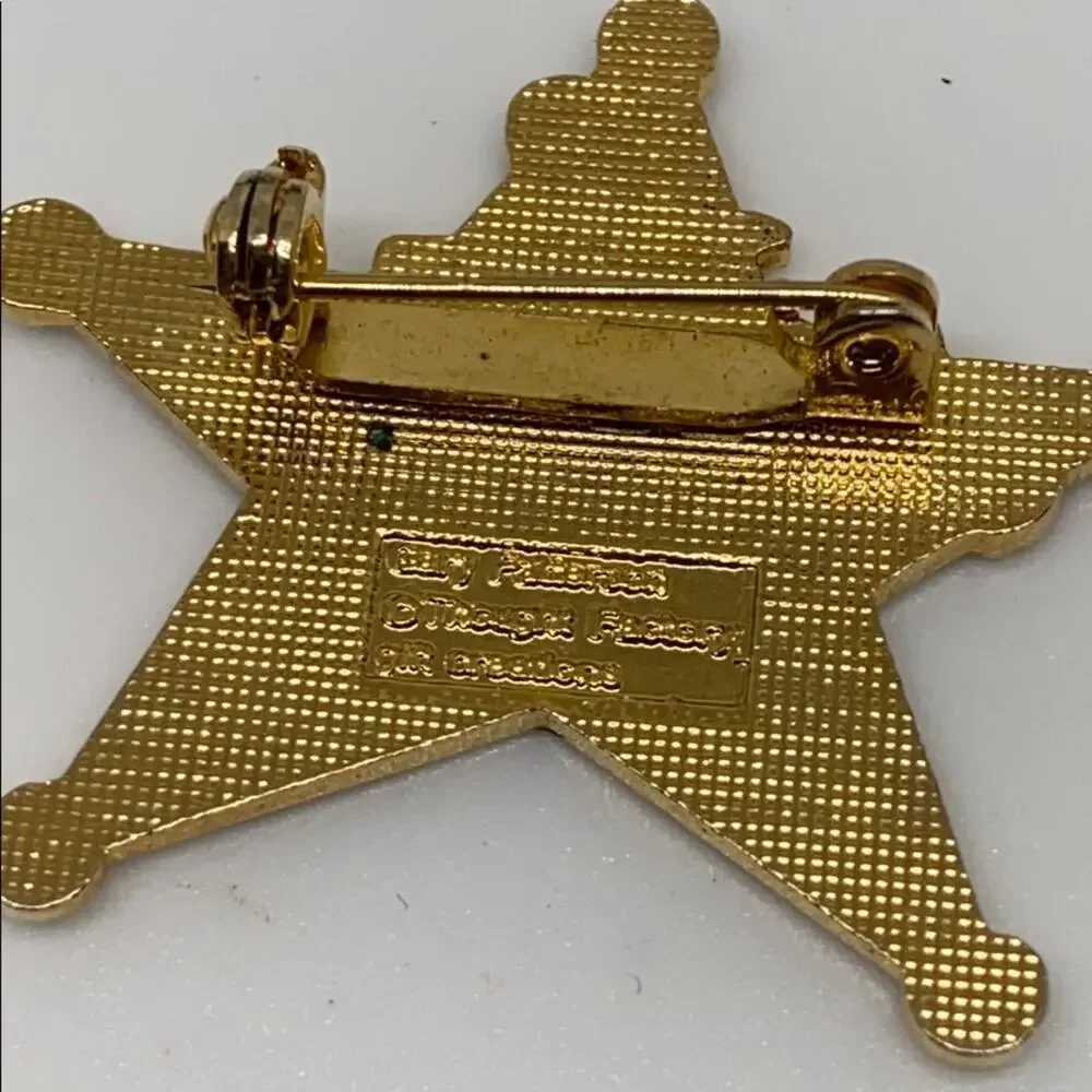 A cowboy on a Rockinghorse sheriff star pin